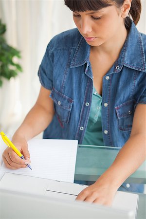 simsearch:640-05761336,k - Unsmiling student doing her homework with her laptop Foto de stock - Super Valor sin royalties y Suscripción, Código: 400-06637235