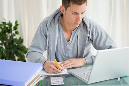 faire - Student doing his homework with a laptop at his desk Photographie de stock - Aubaine LD & Abonnement, Code: 400-06637518