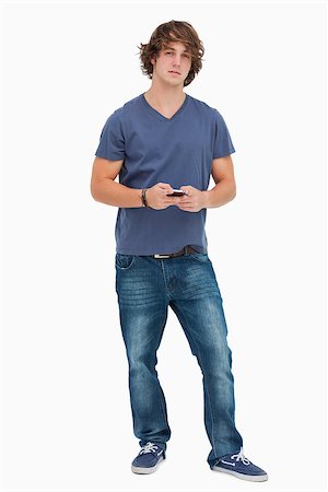 Handsome student holding a cellphone against white background Stock Photo - Budget Royalty-Free & Subscription, Code: 400-06637624