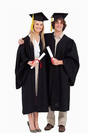 Two students in graduate robe shoulder to shoulder against white background Stock Photo - Budget Royalty-Free & Subscription, Code: 400-06637744