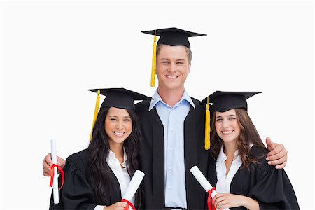 Three friends graduate from college together as they all look into the camera Stock Photo - Budget Royalty-Free & Subscription, Code: 400-06637870