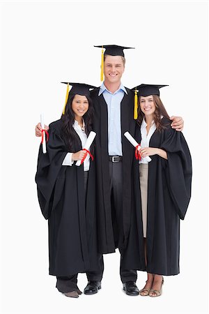 A full length shot of three graduating students looking into the camera Stock Photo - Budget Royalty-Free & Subscription, Code: 400-06637871
