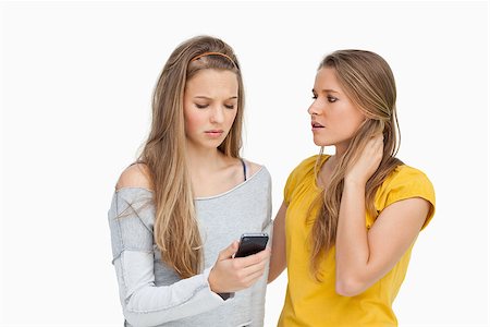 Upset young woman consoled by her friend against white background Stock Photo - Budget Royalty-Free & Subscription, Code: 400-06637937