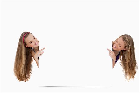 Two long hair women back of a blank sign against white background Stock Photo - Budget Royalty-Free & Subscription, Code: 400-06638099