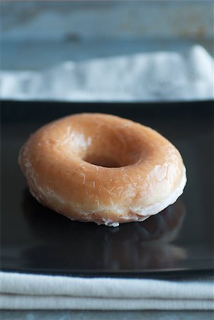 donut hole - Fresh glazed doughnut on square black plate Stock Photo - Budget Royalty-Free & Subscription, Code: 400-06638458