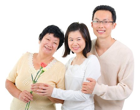 Asian adult offsprings giving carnation flower to senior parent on mother's day. Stock Photo - Budget Royalty-Free & Subscription, Code: 400-06639656