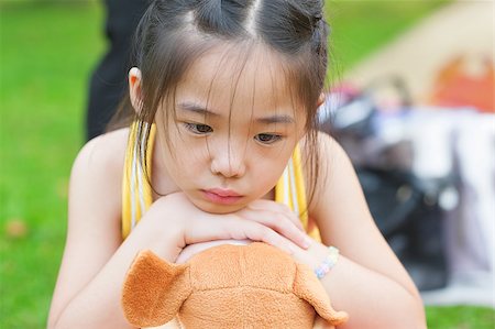 simsearch:400-07173561,k - Outdoor upset Asian child. Little girl showing her unhappy face. Foto de stock - Royalty-Free Super Valor e Assinatura, Número: 400-06639664