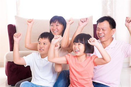 Asian family at home. Portrait of happy parents and children playing game arms raised together at home. Stock Photo - Budget Royalty-Free & Subscription, Code: 400-06639680