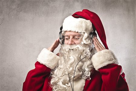 Santa Claus listening to the music with headphones Photographie de stock - Aubaine LD & Abonnement, Code: 400-06639931