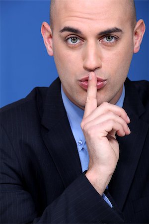 Man holding a finger to his lips Photographie de stock - Aubaine LD & Abonnement, Code: 400-06630855