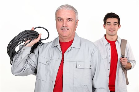 An experienced tradesman posing with his new apprentice Stock Photo - Budget Royalty-Free & Subscription, Code: 400-06630865