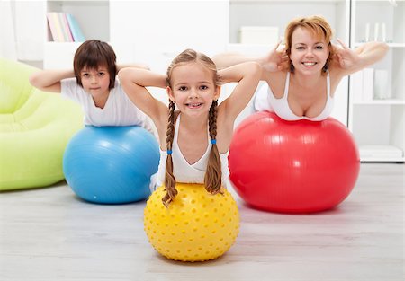 Kids and woman doing gymnastic at home - with large balls Photographie de stock - Aubaine LD & Abonnement, Code: 400-06631156