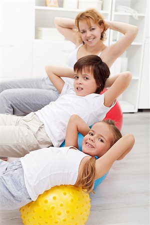 Kids with their mother doing gymnastic exercises with large balls at home Stock Photo - Budget Royalty-Free & Subscription, Code: 400-06631161