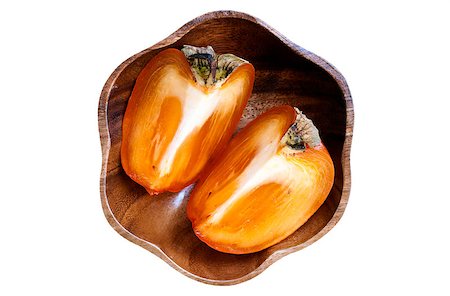 fmgk (artist) - Two quarters of  persimmon in wooden bowl isolated over white background Stock Photo - Budget Royalty-Free & Subscription, Code: 400-06631376