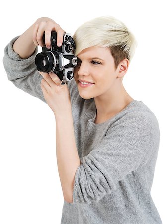 Photo of a beautiful young blond woman holding an old SLR film camera. Stock Photo - Budget Royalty-Free & Subscription, Code: 400-06631679