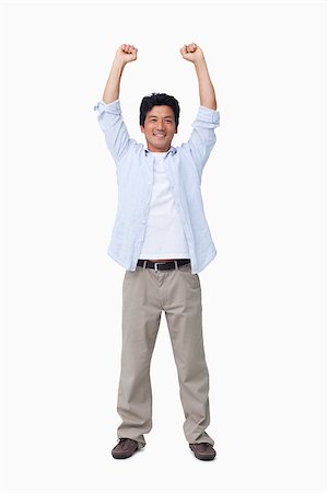 simsearch:400-04343310,k - Cheering male with arms up against a white background Photographie de stock - Aubaine LD & Abonnement, Code: 400-06632193