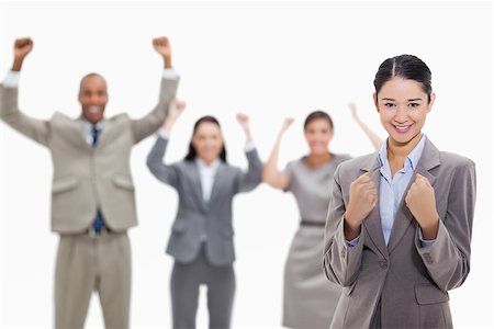 four hand joined - Close-up of a businesswoman smiling and clenching her fists with enthusiastic co-workers in the background Stock Photo - Budget Royalty-Free & Subscription, Code: 400-06632279