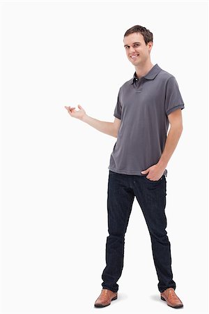 Happy man standing and presenting something behind against white background Stock Photo - Budget Royalty-Free & Subscription, Code: 400-06632388