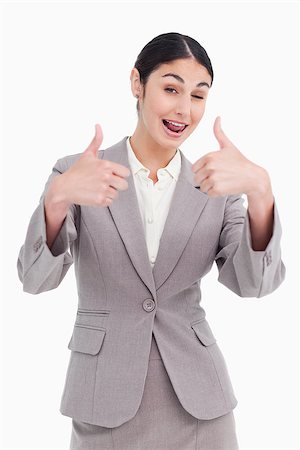 simsearch:400-05898224,k - Cheering businesswoman giving thumbs up against a white background Foto de stock - Royalty-Free Super Valor e Assinatura, Número: 400-06633064