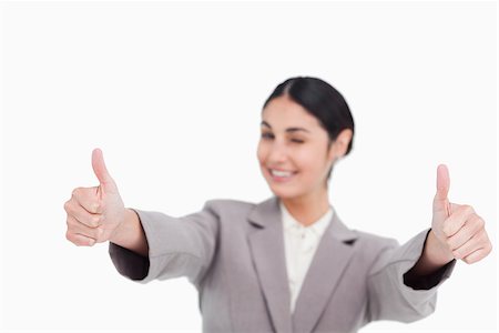 simsearch:400-05898224,k - Thumbs up given by smiling young businesswoman against a white background Foto de stock - Royalty-Free Super Valor e Assinatura, Número: 400-06633081