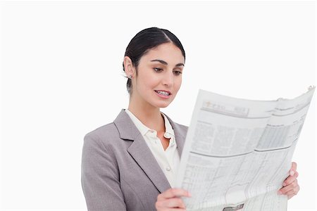 simsearch:632-01157433,k - Businesswoman reading news paper against a white background Stock Photo - Budget Royalty-Free & Subscription, Code: 400-06633116