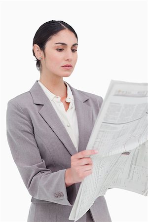 Businesswoman reading the news against a white background Stock Photo - Budget Royalty-Free & Subscription, Code: 400-06633118