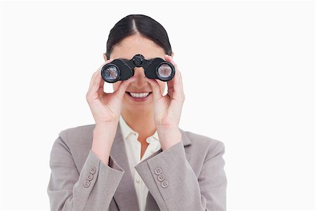 simsearch:400-04554899,k - Smiling businesswoman looking through spy glasses against a white background Stock Photo - Budget Royalty-Free & Subscription, Code: 400-06633113