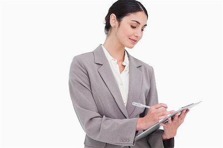 simsearch:400-06633122,k - Businesswoman taking notes against a white background Stock Photo - Budget Royalty-Free & Subscription, Code: 400-06633122