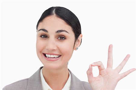 simsearch:400-05898224,k - Close up of smiling businesswoman giving her approval against a white background Foto de stock - Royalty-Free Super Valor e Assinatura, Número: 400-06633139