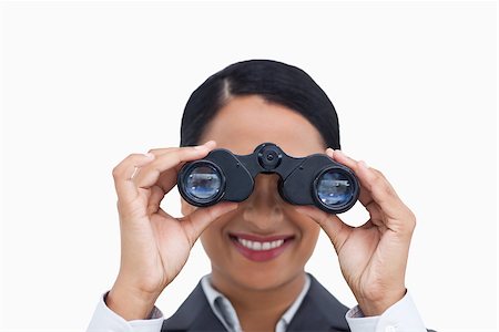 simsearch:400-04554899,k - Close up of smiling saleswoman using spy glasses against a white background Stock Photo - Budget Royalty-Free & Subscription, Code: 400-06633166