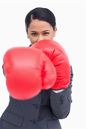 simsearch:400-05718453,k - Close up of saleswoman with boxing gloves attacking against a white background Stock Photo - Budget Royalty-Free & Subscription, Code: 400-06633203