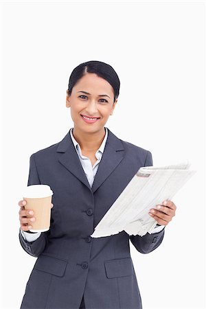 Close up of smiling saleswoman with paper cup and newspaper against a white background Photographie de stock - Aubaine LD & Abonnement, Code: 400-06633215