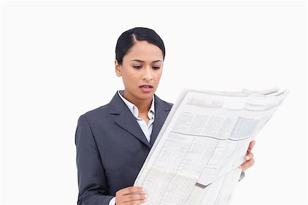 Close up of saleswoman reading news paper against a white background Stock Photo - Budget Royalty-Free & Subscription, Code: 400-06633210