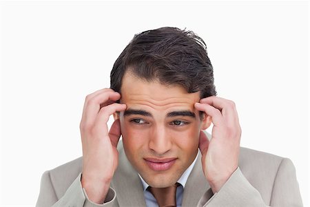 Close up of salesman having a headache against a white background Stock Photo - Budget Royalty-Free & Subscription, Code: 400-06633323