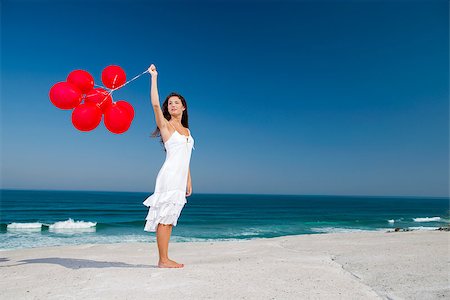 Beautiful girl with red ballons in the beach Stock Photo - Budget Royalty-Free & Subscription, Code: 400-06633412