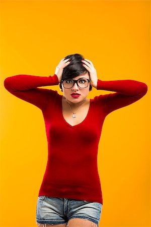 funny looking girls with glasses - Nerd girl angry with something, aganist a yellow background Stock Photo - Budget Royalty-Free & Subscription, Code: 400-06633452