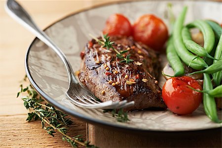 Rustic steak with vegetables and herbs on a plate Stock Photo - Budget Royalty-Free & Subscription, Code: 400-06633475