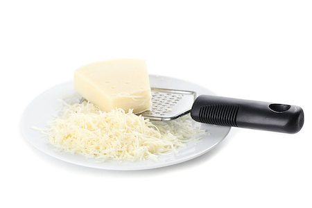 rallador de queso - Grated cheese and grater on a plate isolated on white background Foto de stock - Super Valor sin royalties y Suscripción, Código: 400-06633653