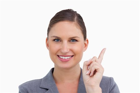 finger pointing up - Close up of smiling tradeswoman pointing up against a white background Stock Photo - Budget Royalty-Free & Subscription, Code: 400-06633978