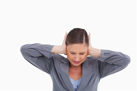 disturb sign - Close up of irritated tradeswoman covering her ears against a white background Stock Photo - Budget Royalty-Free & Subscription, Code: 400-06633987