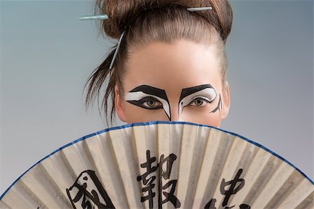 sexy brunette with japan make-up and asian fan, she takes the fan on the face and her mouth and her nose are hidden Stock Photo - Budget Royalty-Free & Subscription, Code: 400-06644255