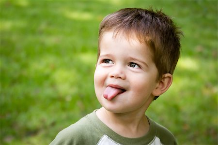 Cute little boy with brown hair sticking out his tongue Stock Photo - Budget Royalty-Free & Subscription, Code: 400-06644282