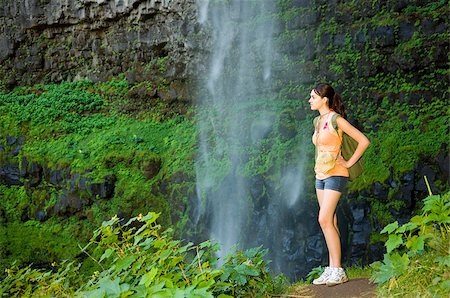 simsearch:400-03965342,k - Young woman hiking in summer near waterfall. Foto de stock - Royalty-Free Super Valor e Assinatura, Número: 400-06642389