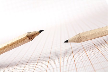 Two wooden pencils on graph paper background Stock Photo - Budget Royalty-Free & Subscription, Code: 400-06642717