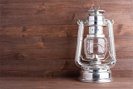silver antique - Old kerosene lantern on the dark wooden background Stock Photo - Budget Royalty-Free & Subscription, Code: 400-06643924