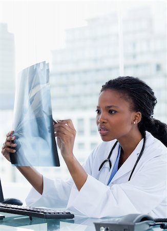 simsearch:400-06634198,k - Portrait of a focused female doctor looking at a set of X-rays in her office Stock Photo - Budget Royalty-Free & Subscription, Code: 400-06685228