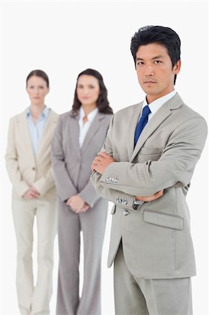 simsearch:400-07186359,k - Confident looking businessman with his team behind him against a white background Stock Photo - Budget Royalty-Free & Subscription, Code: 400-06685636