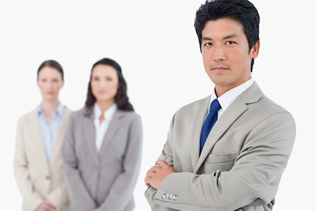 simsearch:400-07186359,k - Confident businessman with employees behind him against a white background Stock Photo - Budget Royalty-Free & Subscription, Code: 400-06685640