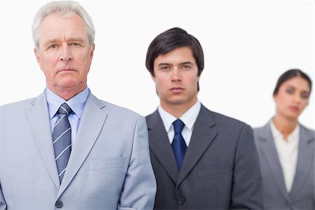 simsearch:6109-06002735,k - Mature salesman standing with employees against a white background Stock Photo - Budget Royalty-Free & Subscription, Code: 400-06686527