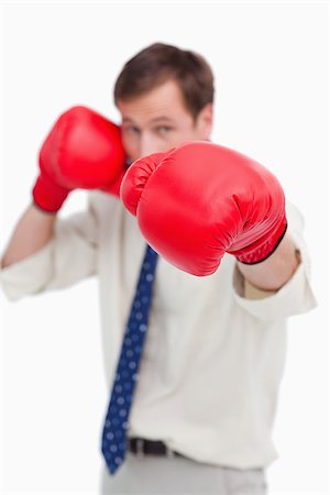 simsearch:400-04425597,k - Attacking businessman with boxing gloves against a white background Foto de stock - Super Valor sin royalties y Suscripción, Código: 400-06686867